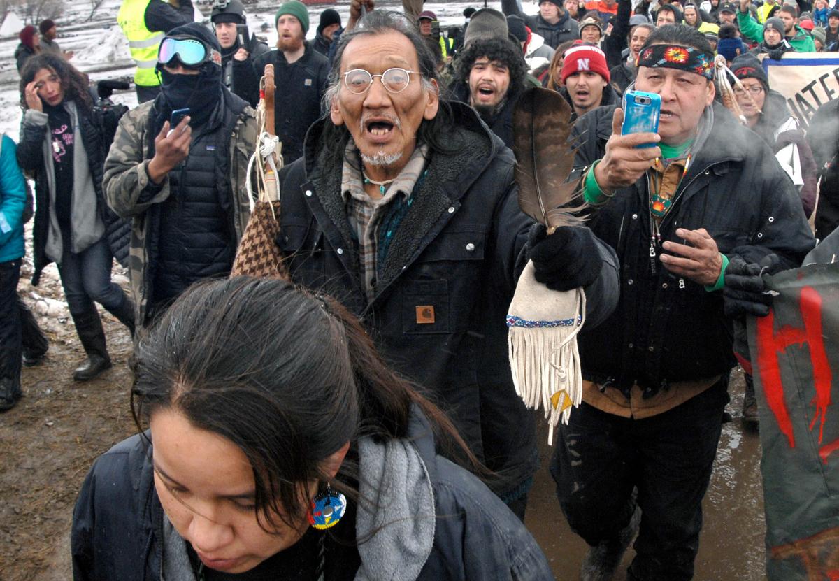 In this Feb. 22, 2017, file photo, Nathan Phillips, center with glasses, and other Dakota Access Pipeline protesters march in North Dakota. (Mike McCleary/The Bismarck Tribune via AP, File)