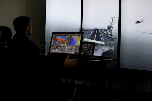 Military helicopter pilot Henery Jacobs uses a fixed wing flight simulator at Coast Flight Training in San Diego, California, U.S., January 15, 2019. REUTERS/Mike Blake
