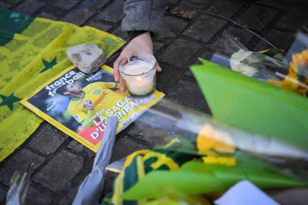 An FC Nantes football club supporter places a candle in Nantes two days after it was announced that the plane carrying Argentine forward Emiliano Sala vanished during a flight from Nantes in western France to Cardiff in Wales, on Jan. 23, 2019. (Loic Venance/AFP/Getty Images)