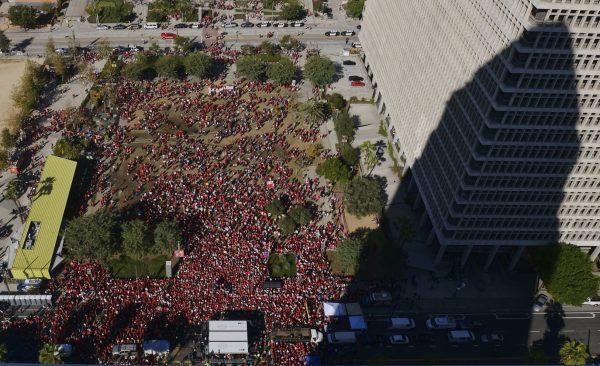 The shadow of Los Angeles City Hall is cast on a building while striking Los Angeles Unified teachers gather in Grand Park in L.A., on Jan. 22, 2019. (Richard Vogel/AP)
