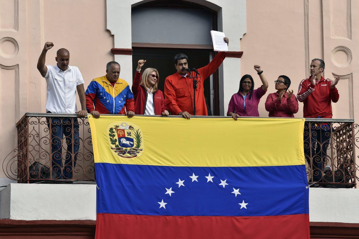 Venezuela's President Nicolas Maduro (C), speaks to a crowd of supporters flanked by his wife Cilia Flores (2-L), Venezuelan Vice-president Delcy Rodriguez (R) the head of Venezuela's Constituent Assembly Diosdado Cabello, along with other members of the government, to announce his is breaking off diplomatic ties with the United States, during a gathering in Caracas on Jan. 23, 2019. (Luis Robayo/AFP/Getty Images)