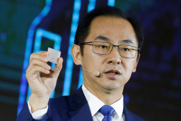 Ryan Ding, Huawei president of the carrier business group, holds a Tiangang 5G base station chipset during a product presentation in Beijing on Jan. 24, 2019. (REUTERS/Thomas Peter)