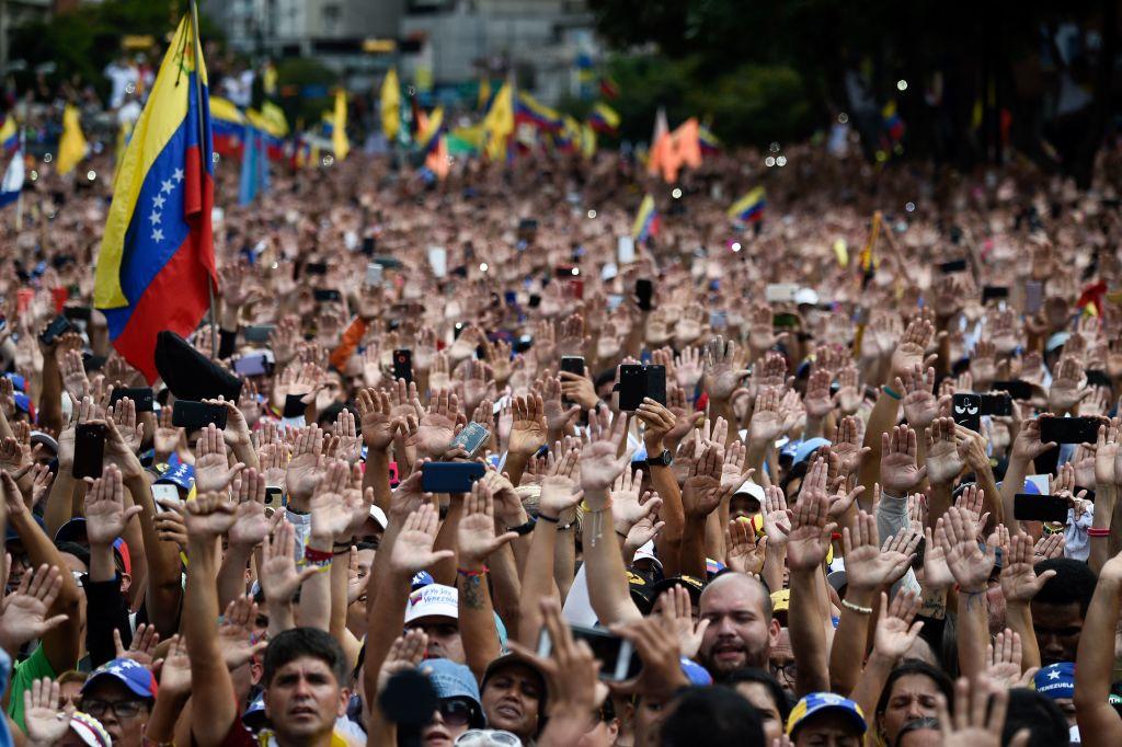People raise their hands during a mass opposition rally against President Nicolas Maduro in which Venezuela's National Assembly head Juan Guaido declared himself the country's "acting president" in Caracas on Jan. 23, 2019. (FEDERICO PARRA/AFP/Getty Images)