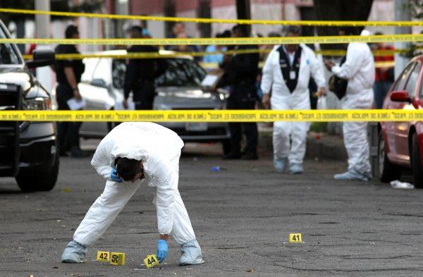 Forensic experts are seen at the scene of a crime in Guadalajara, Jalisco state, on Jan. 18, 2019. (Ulises Ruiz/ AFP/Getty Images)