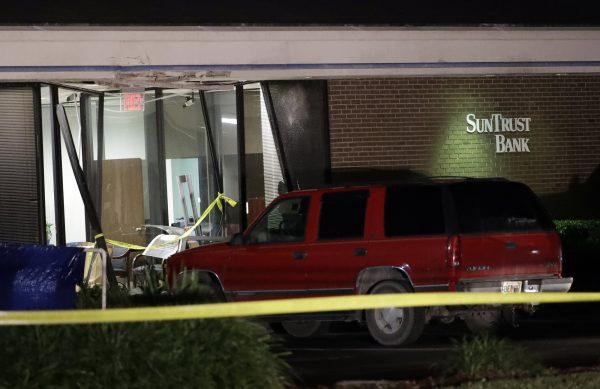 A red SUV is seen parked outside the damaged SunTrust bank early on Jan. 24, 2019, in Sebring, Fla. (AP Photo/Chris O'Meara)