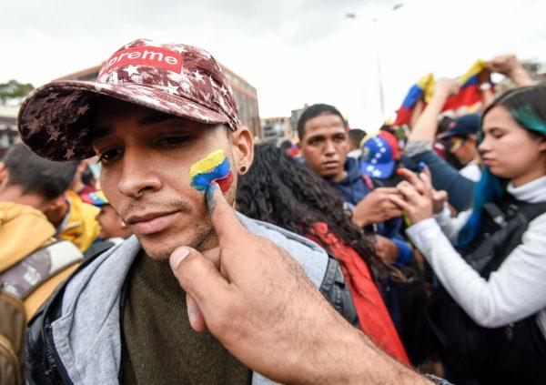 Venezuelans opposed to President Nicolas Maduro hold a demonstration in Bogota, Colombia, in support of opposition leader Juan Guaido's self-proclamation as acting president of Venezuela, on Jan. 23, 2019. (Juan Barreto/AFP/Getty Images)