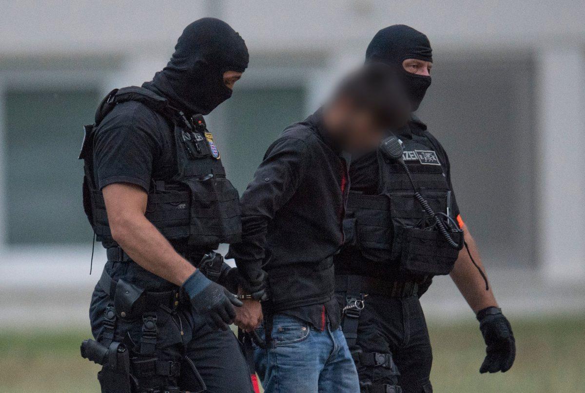 Law enforcement officers escort suspect Ali Bashar to police headquarters in Wiesbaden, Germany, on June 10, 2018. (Boris Roessler/AFP/Getty Images)