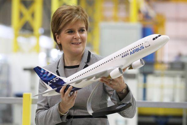 Scottish First Minister Nicola Sturgeon holds a model of an Airbus 320 after making a keynote speech on Scotland economy at Spirit Aerospace in Prestwick where she was also given a tour of the factory in Prestwick, Scotland, on Aug. 31, 2017. (Andrew Milligan/WPA/Pool/Getty Images)