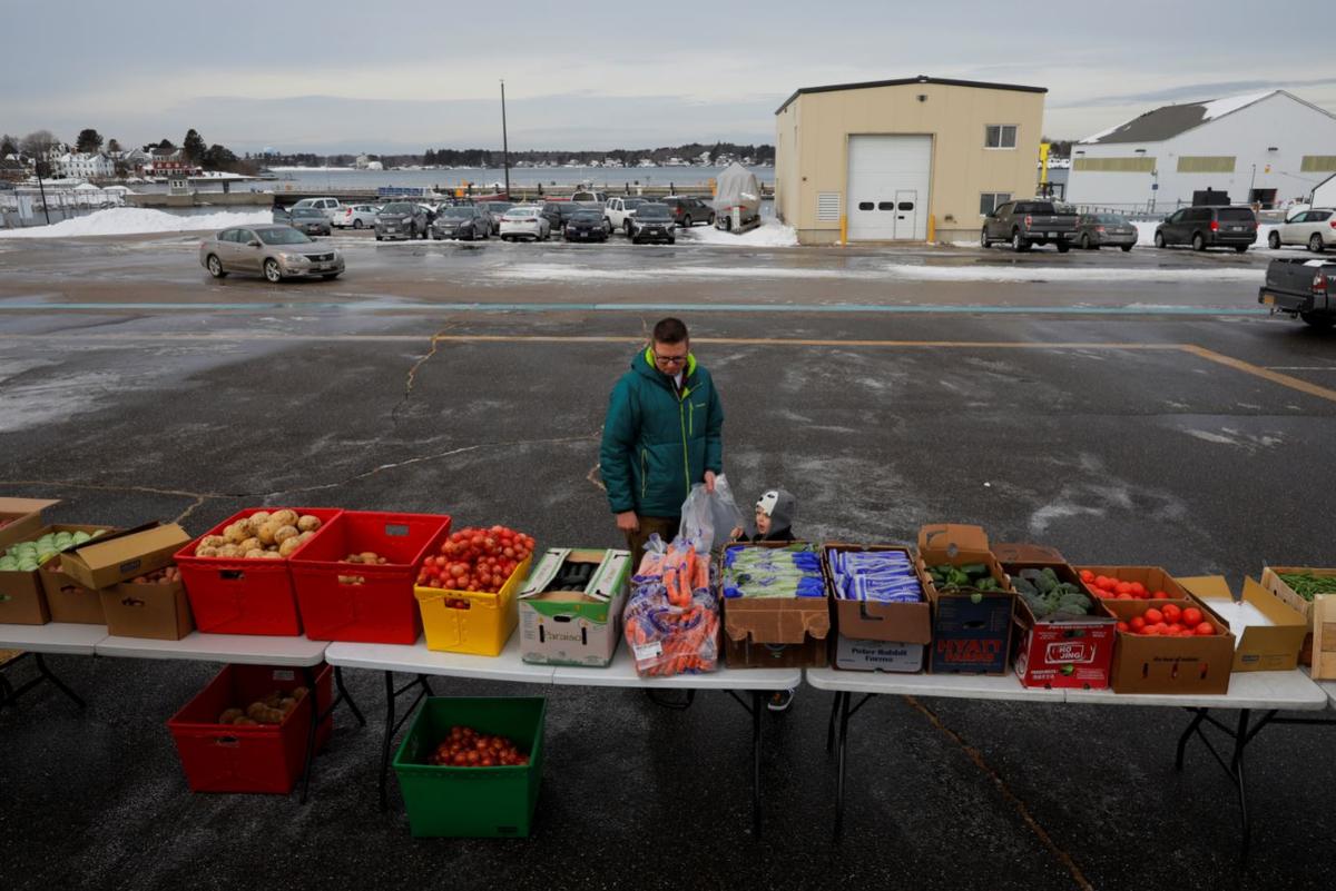 Members of the U.S. Coast Guard working without pay during the government shutdown and their families pick up produce, eggs, milk, bread and other supplies being distributed by Gather food pantry at the U.S. Coast Guard Portsmouth Harbor base in New Castle, New Hampshire, U.S., Jan. 23, 2019. (Reuters/Brian Snyder)