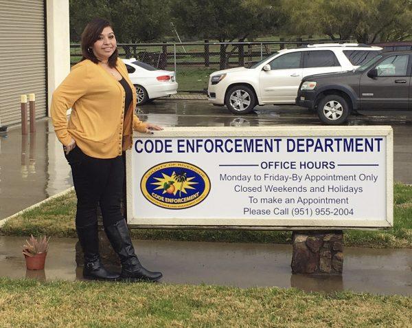 This undated photo provided by the County of Riverside Code Enforcement Department shows code enforcement employee Angie Solis standing outside the agency's office in Riverside, Calif. (County of Riverside Code Enforcement Department/AP)