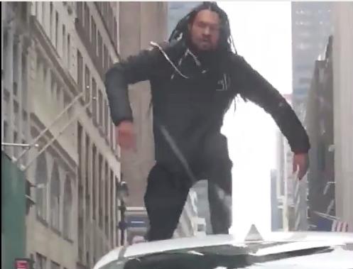 An unknown assailant climbs onto an Uber roof on Jan. 18, 2019. (Screenshot/NYP)