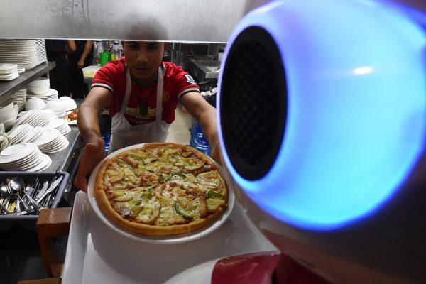 'Please enjoy your meal,' says Nepal's first robot waiter, Ginger, as she delivers a plate of steaming dumplings to a table of hungry customers at Naulo restaurant in Kathmandu. (Prakash Mathema/AFP/Getty Images)