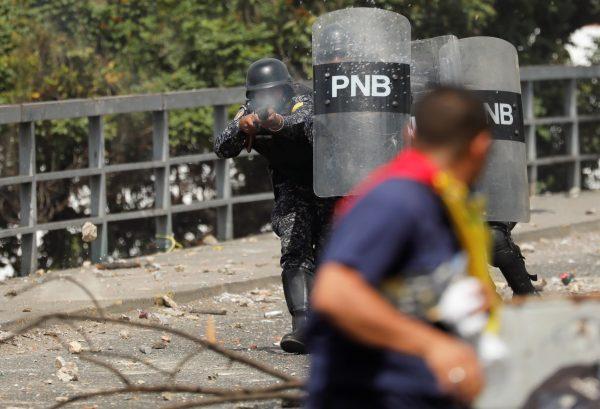 A police officer fires rubber bullets during a protest against Venezuelan President Nicolas Maduro's government in Caracas, Venezuela, on Jan. 23, 2019. (Manaure Quintero/Reuters)