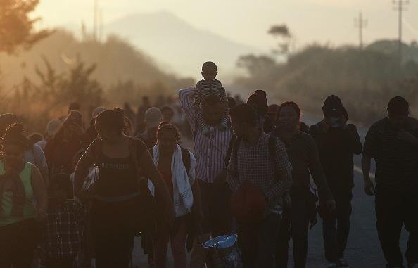 People from a caravan of Central American migrants walk along a highway on their way to the United States, near Santo Domingo Zanatepec in Mexico, on Jan. 22, 2019. (Photo by Mario Tama/Getty Images)