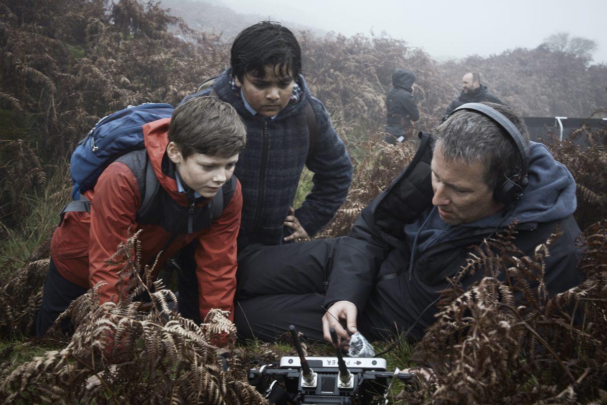(L–R) Louis Ashbourne Serkis, Dean Chaumoo, and director Joe Cornish on the set of “The Kid Who Would Be King.” (Kerry Brown/Twentieth Century Fox)