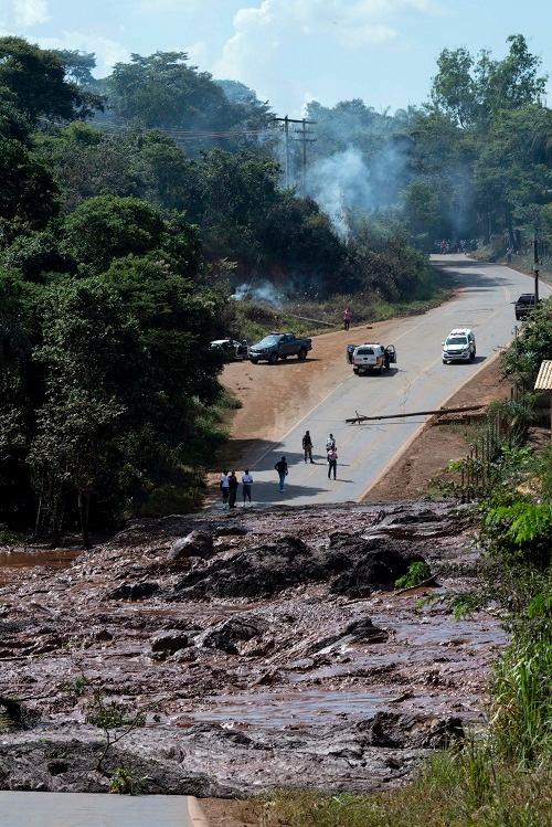 A road is blocked after a dam collapsed near Brumadinho, Brazil, Friday, Jan. 25, 2019. Brazilian mining company Vale SA said it didn’t yet have information on deaths or injuries at the dam but said that tailings have reached the community of Vila Ferteco. (Leo Drumond/Nitro via AP)