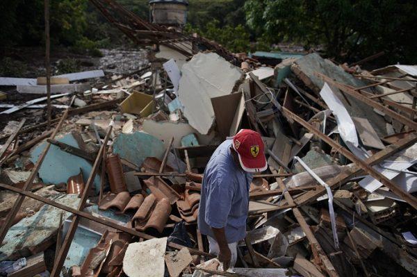 A man stands in the debris of his home that was destroyed after a dam collapsed, near Brumadinho, Brazil, on Jan. 26, 2019. (Leo Correa/AP Photo)