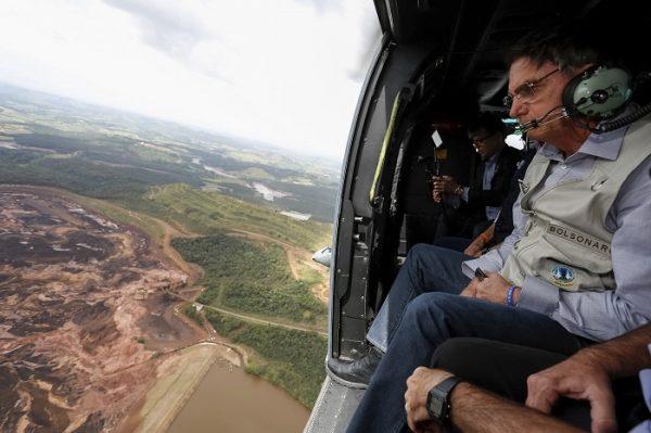Brazil's President Jair Bolsonaro surveys an area buried by mud, in Brumadinho, Brazil, on Jan. 26, 2019. (Isac Nobrega/Brazil's Government Press Office via AP)