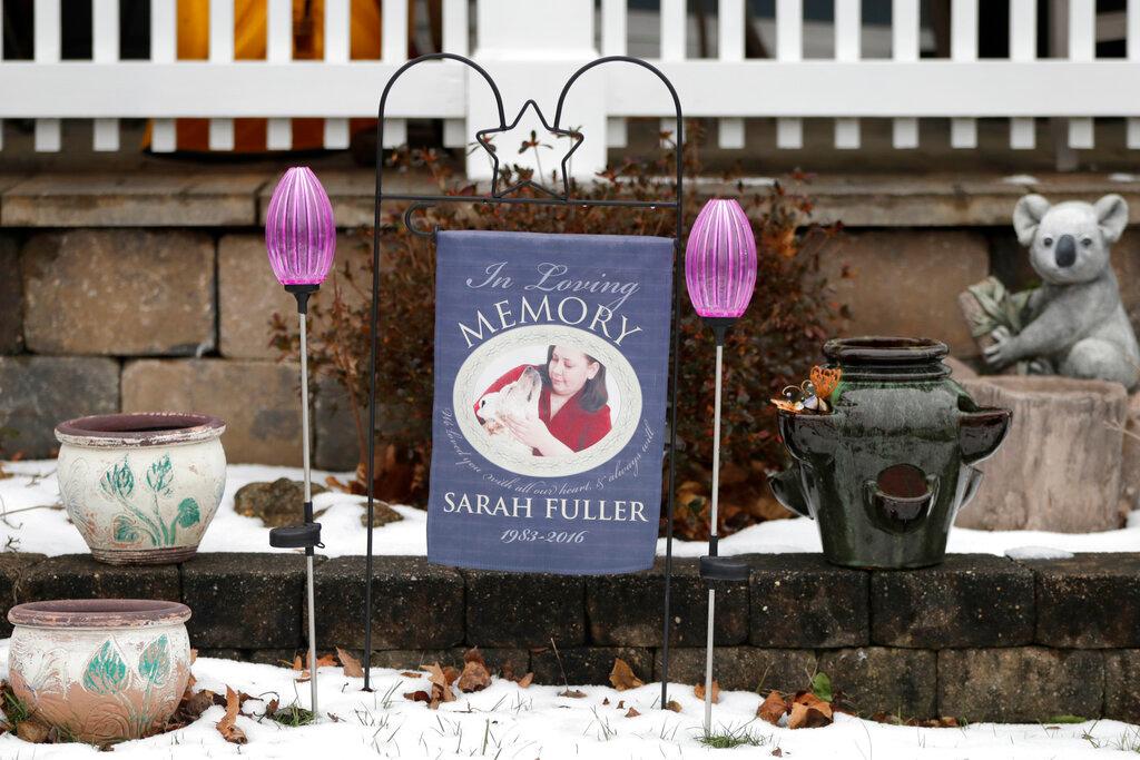 In a photo taken Friday, Jan. 18, 2019, a small memorial in honor of Sarah Fuller, who passed of a prescription drug overdose, is displayed in the yard of her mother Deborah Fuller's home in West Berlin, N.J. The trial of the Insys Therapeutics Inc. founder John Kapoor, who accused of scheming to bribe doctors into prescribing a powerful painkiller, is putting a spotlight on the nation's deadly opioid crisis. (AP Photo/Julio Cortez)
