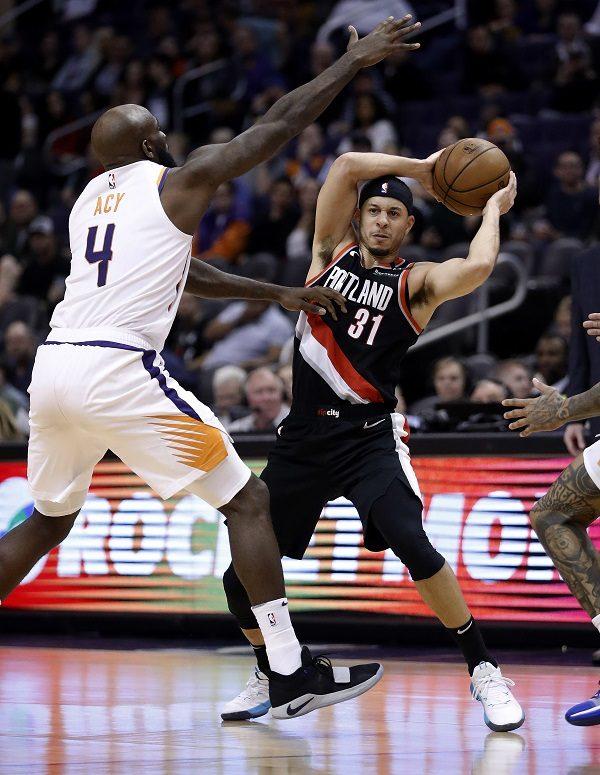 Portland Trail Blazers guard Seth Curry (31) looks to pass the ball as Phoenix Suns forward Quincy Acy (4) defends during the second half of an NBA basketball game in Phoenix, on Jan. 24, 2019. (Matt York/AP Photo)