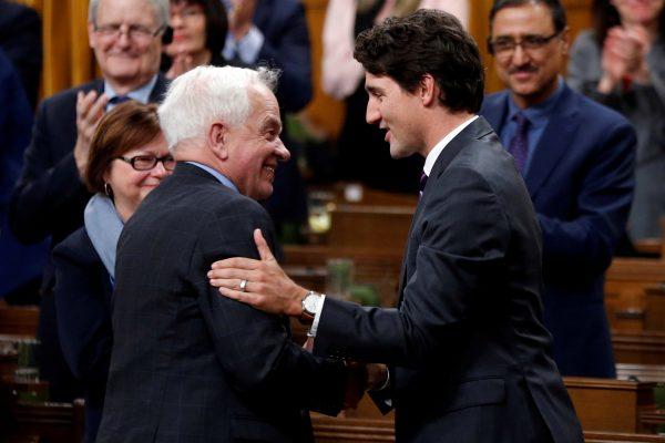 Canadian Prime Minister Justin Trudeau (R) shakes hands with John McCallum, now Canada’s former ambassador to China, on Jan. 31, 2017. (Reuters/Chris Wattie/File Photo)