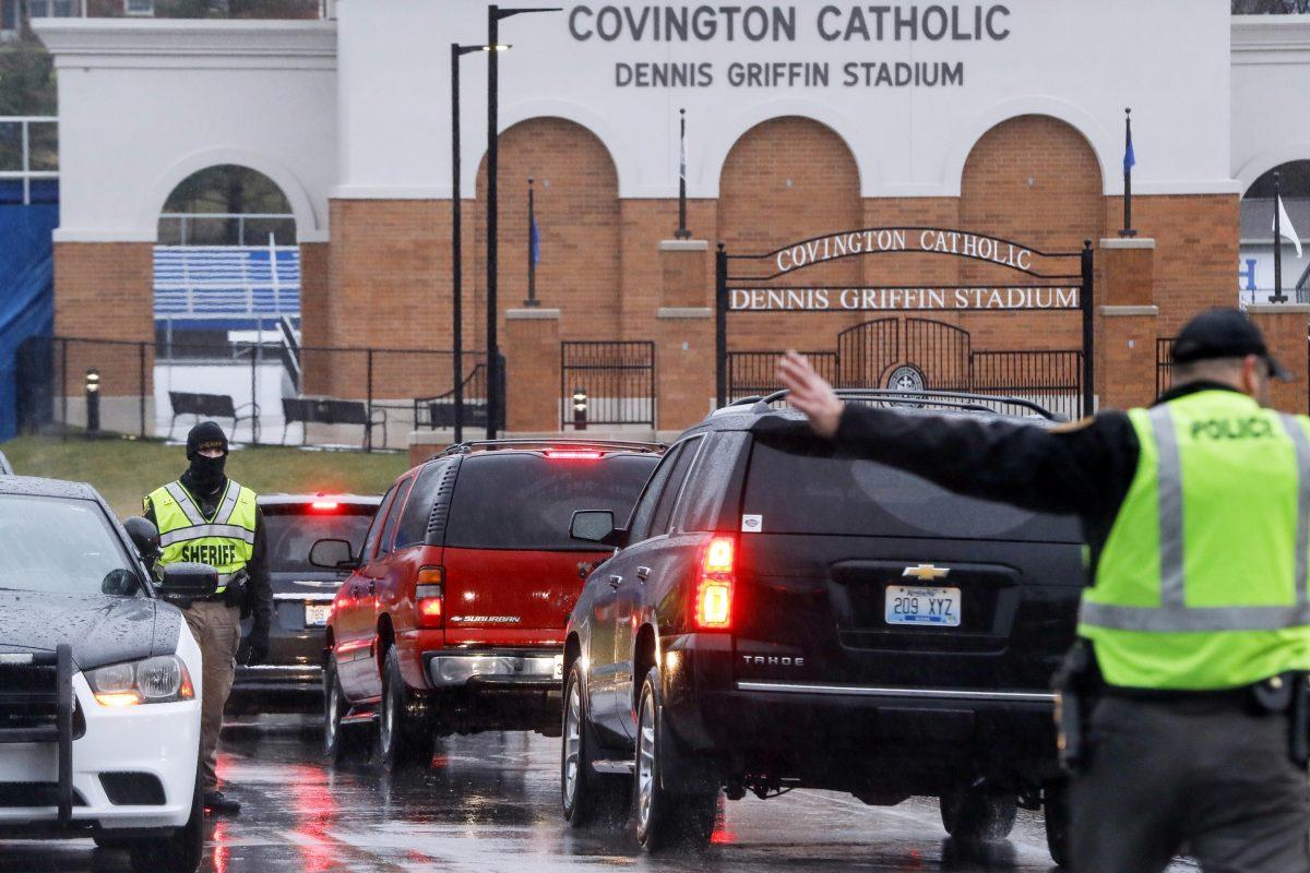 Students arrive at Covington Catholic High School as classes resume following a closing due to security concerns the previous day on Jan. 23, 2019, in Park Hills, Ky. Local police authorities controlled access to the property at entrances and exits. (AP Photo/John Minchillo)