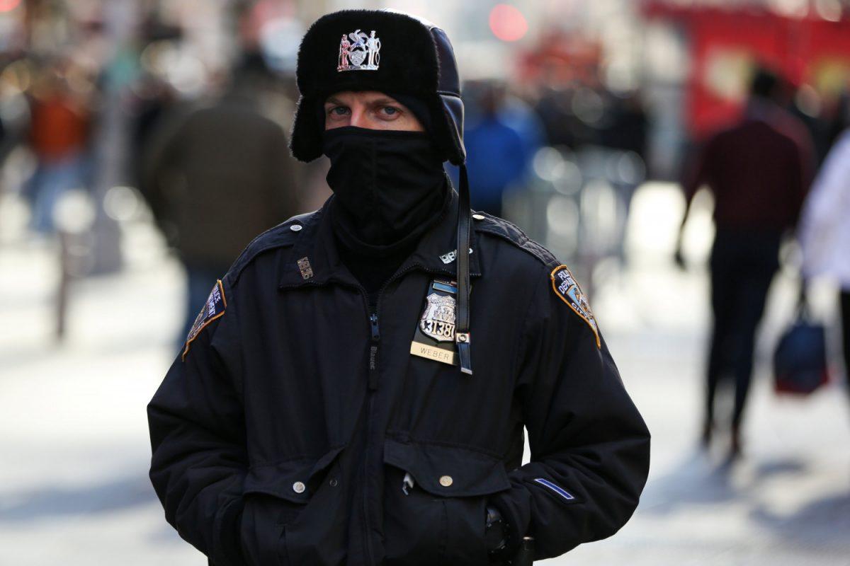 A New York Police Department officer bundles up against the cold temperature as he walks in Times Square in Manhattan, New York, on Dec. 28, 2017. (Amr Alfiky/Reuters)
