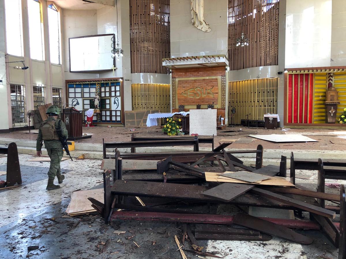 A Philippine Army member inspects the damage inside a church after a bombing attack in Jolo, Sulu province, Philippines January 27, 2019. Armed Forces Of The Philippines (Western Mindanao Command/Handout via Reuters)