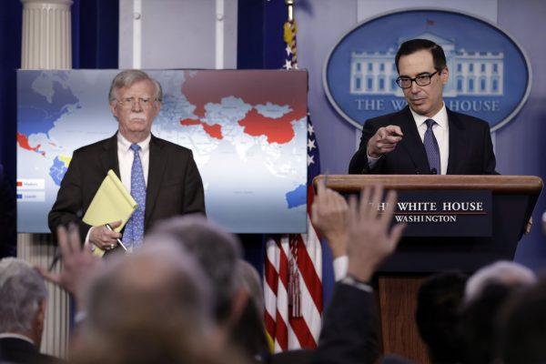 National security adviser John Bolton (R) and Treasury Secretary Steven Mnuchin during a press briefing at the White House, on Jan. 28, 2019. (Evan Vucci/AP Photo)