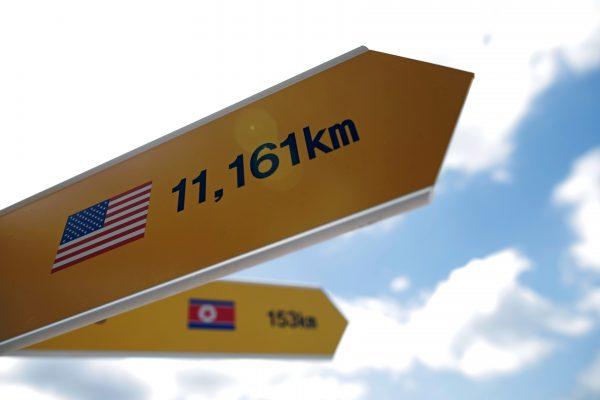 Directional signs bearing North Korean and U.S. flags are seen near the demilitarized zone in Paju, South Korea, June 12, 2018. (Kim Hong-Ji/Reuters)