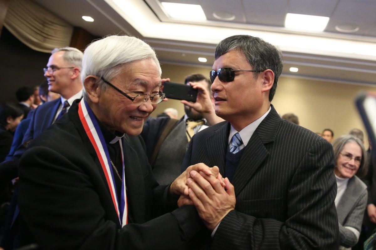 Chen Guangcheng, blind Chinese civil rights activist and lawyer (R), greets Cardinal Joseph Zen, recipient of the Truman-Reagan Medal of Freedom during a ceremony at the Rayburn House Office Building on Capitol Hill in Washington on Jan. 28, 2019. (Samira Bouaou/The Epoch Times)