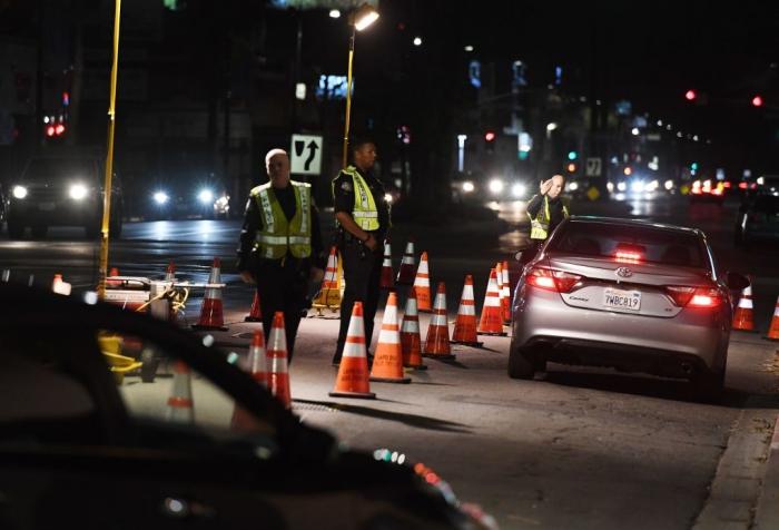 Police officers check drivers at a DUI checkpoint in a file photograph. (Mark Ralston/Getty Images)
