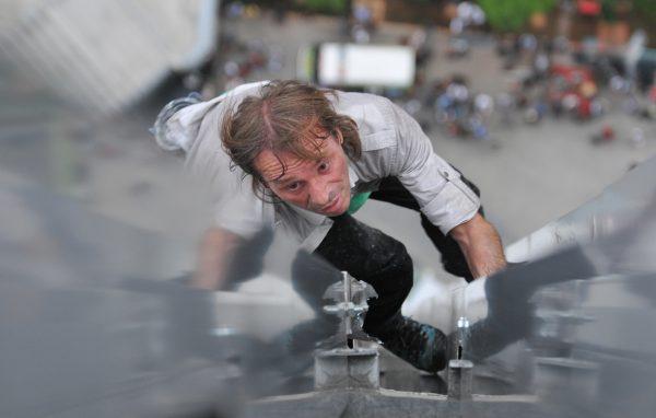 Alain Robert climbs a 33-floor building in Jakarta on Nov. 12, 2008. (Bay Ismoyo/AFP/Getty Images)