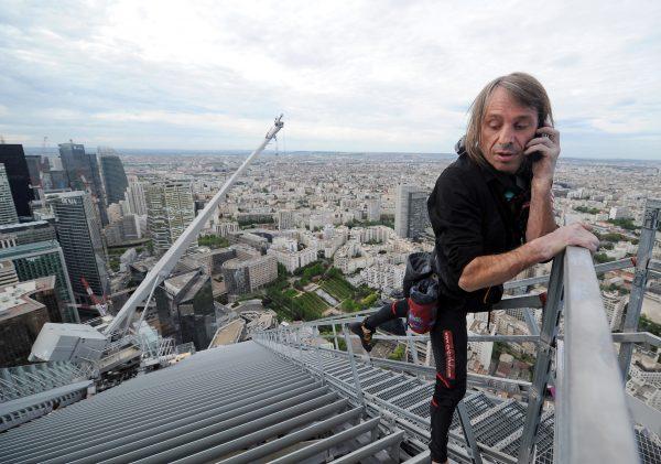 Alain Robert after climbing the 757-foot tall First Tower, the tallest skyscraper in France, outside Paris on May 10, 2012. (Franck Fife/AFP/Getty Images)