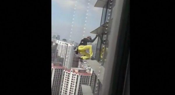 Alain Robert climbs the GT Tower in Manila, captured on video by people inside the building, on Jan. 29, 2019. (Screenshot/Reuters)
