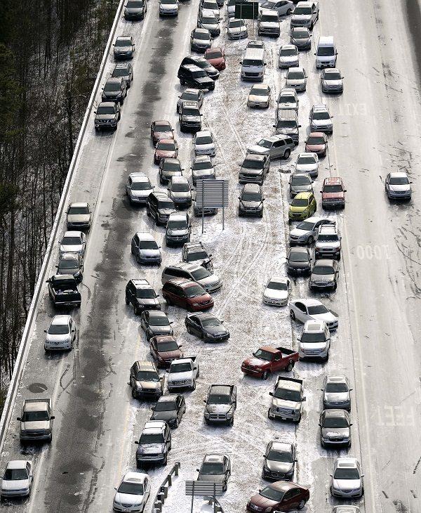 Abandoned cars at I-75 headed northbound near the Chattahoochee River overpass are piled up in the median of the ice-covered interstate after a winter snow storm, in Atlanta, on Jan. 29, 2014. (David Tulis/AP Photo, File)