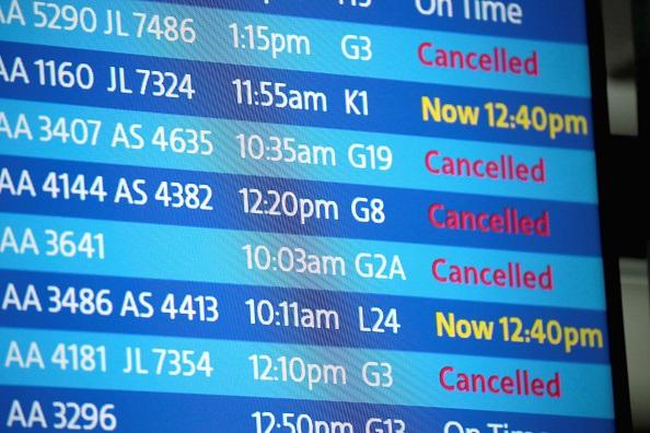 An electronic board shows flight delays and cancellations at O'Hare International Airport after an early winter snowstorm left more than 7 inches of snow at the airport in Chicago, Illinois, on Nov. 26, 2018. (Scott Olson/Getty Images)