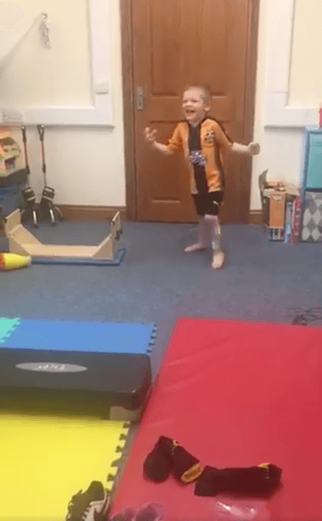 Four-year-old Ronnie with cerebral palsy shouts with joy as he walks his first steps without splints after an operation. (Steve Leys/Twitter)