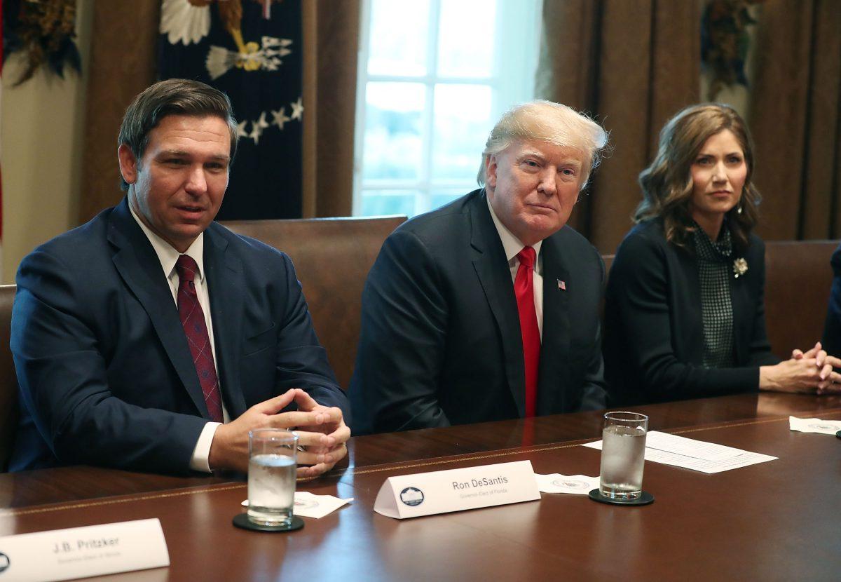 South Dakota Governor-elect Kristi Noem (R) sits sits next to U.S. President Donald Trump and Florida Governor-elect Ron DeSantis (L) at the White House in Washington on Dec. 13, 2018. (Mark Wilson/Getty Images)