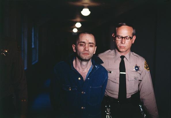 Charles Manson, convicted hippie leader, is sullen as he is led back into the courtroom to hear the penalty he and this three female followers must pay for the Tate-LaBianca murders of August 1969.  (Rolls Press/Popperfoto/Getty Images)