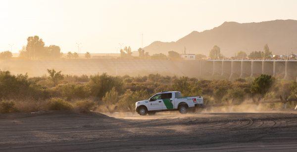 A Border Patrol truck drives by the U.S.–Mexico border near Yuma, Ariz., on May 25, 2018. (Samira Bouaou/The Epoch Times)