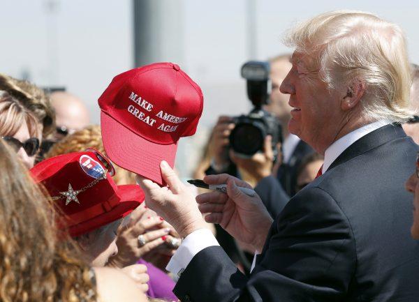 President Donald Trump hands a signed "Make America Great Again," hat back to a supporter in Reno, Nev. on Aug. 23, 2017. An award-winning chef and California restaurant owner said anyone wearing a red "Make America Great Again" baseball cap will be refused service at his restaurant. J. Kenji Lopez-Alt is a chef-partner of the Wursthall restaurant in San Mateo and says in a tweet Sunday, Jan. 27, 2019, that he views the hats as symbols of intolerance and hate. (Alex Brandon/AP Photo, File)
