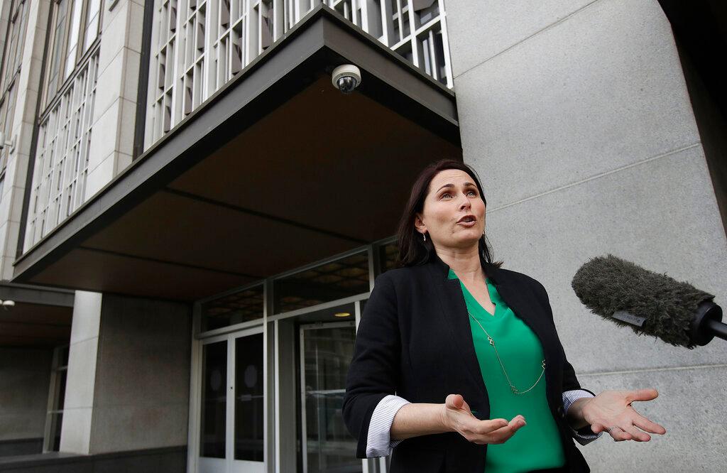 Amanda Riddle, an attorney representing wildfire victims, speaks with a reporter outside of a Federal Courthouse in San Francisco, Tuesday, Jan. 29, 2019. Faced with potentially ruinous lawsuits over California's recent wildfires, Pacific Gas & Electric Corp. filed for bankruptcy protection Tuesday in a move that could lead to higher bills for customers of the nation's biggest utility and reduce the size of any payouts to fire victims. (AP Photo/Jeff Chiu)