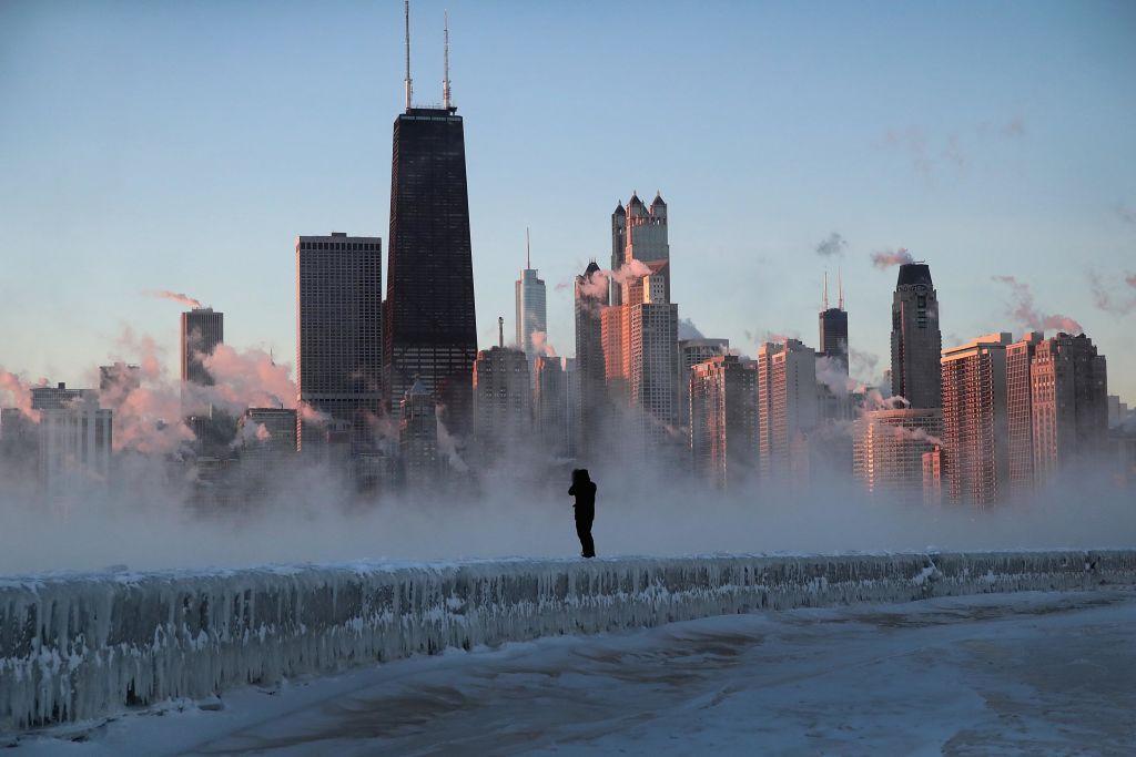 A man walks along an ice-covered break-wall along Lake Michigan while temperatures were hovering around -20 degrees and wind chills nearing -50 degrees on Jan. 31, 2019 in Chicago, Illinois. (Scott Olson/Getty Images)