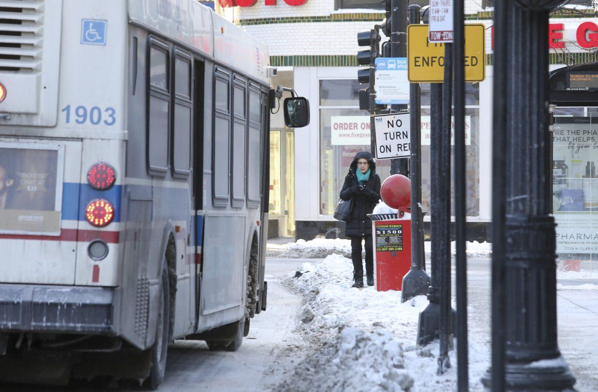 A lone commuter waits for a bus in Chicago on Jan. 30, 2019. A deadly arctic deep freeze enveloped the Midwest with record-breaking temperatures triggering widespread closures of schools and businesses. (Teresa Crawford/AP Photo)