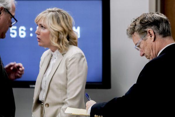 (R) U.S. Sen. Rand Paul (R-Ky.), makes notes as his wife Kelley Paul talks with Paul's attorney Tom Kerrick during the second day of a civil trial involving Paul and his neighbor Rene Boucher in Warren Circuit Court in Bowling Green, Ky on Jan. 29, 2019. (Bac Totrong/Daily News via AP)
