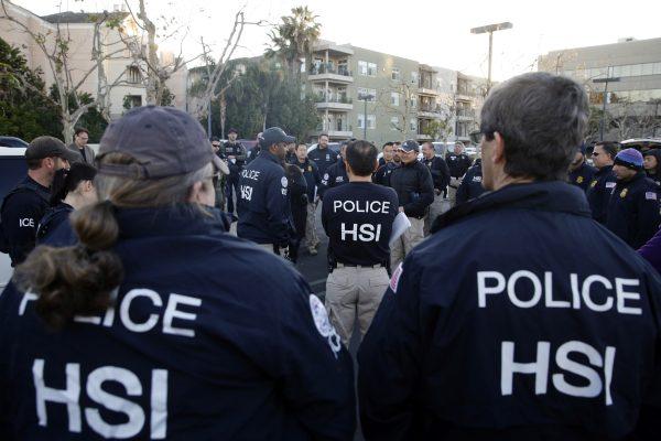Federal agents gather at a nearby parking lot before raiding an upscale apartment complex where authorities say a birth tourism business charged pregnant women $50,000 for lodging, food and transportation in Irvine, California, U.S. on March 3, 2015. (Jae C. Hong/AP)