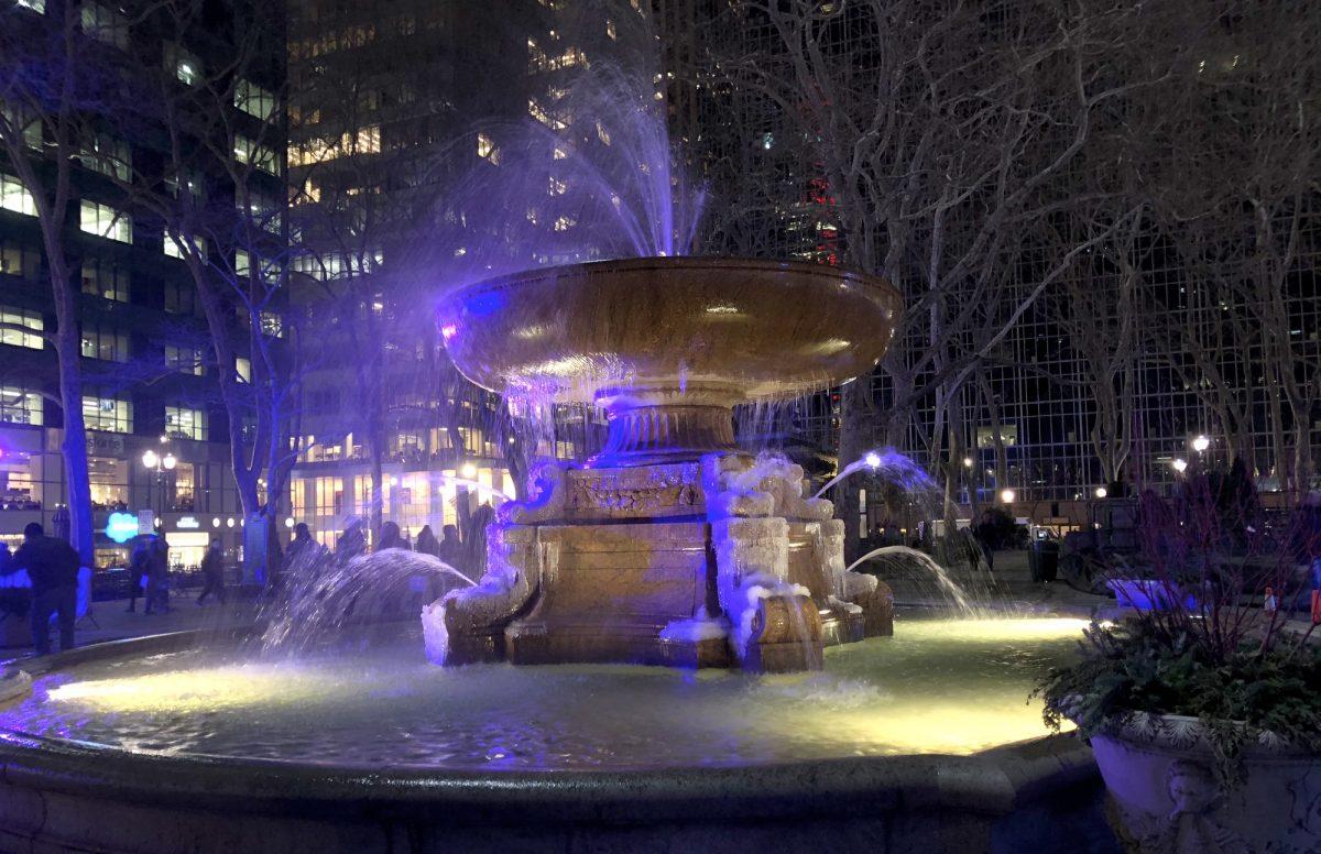 The Bryant Park fountain on an evening in Manhattan. (Shelbi Malonson/The Epoch Times)
