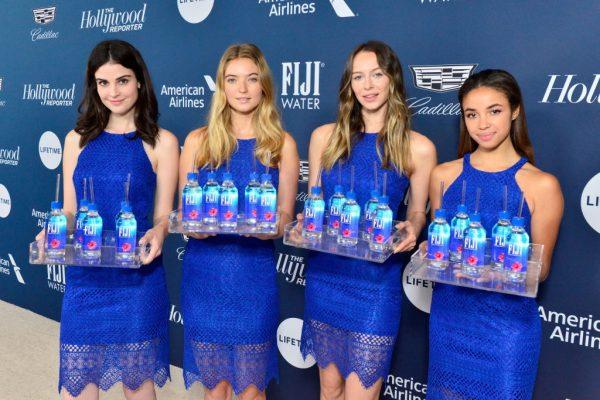 Models hold samples of Fiji brand water at the Hollywood Reporter's 27th Annual Women In Entertainment Breakfast in Los Angeles, Cali. on Dec. 5, 2018. (Jerod Harris/Getty Images for FIJI Water)