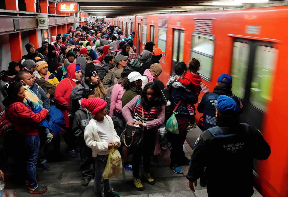 Migrants prepare to get into a train at an underground station during their journey to the United States, in Mexico City, Mexico, on Jan. 31, 2019. (Alexandre Meneghini/Reuters)